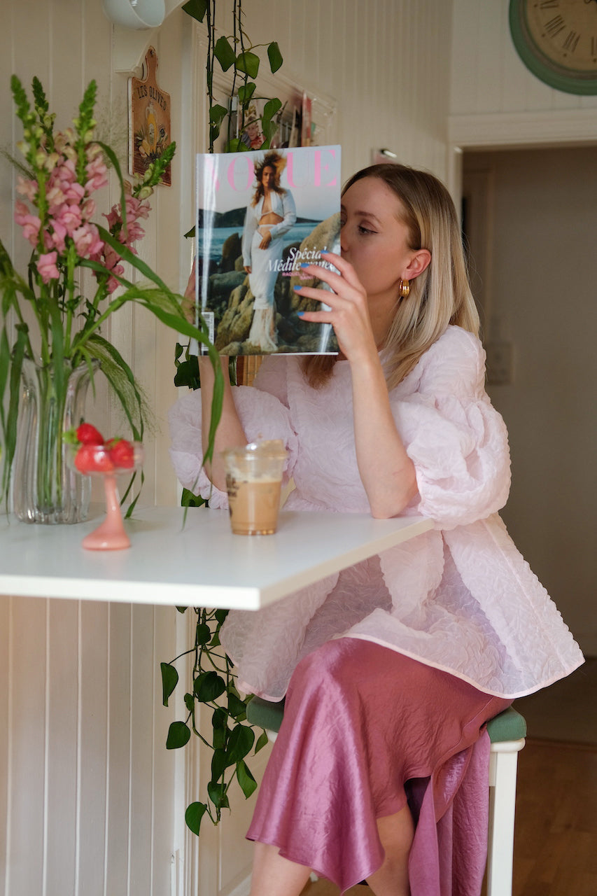 Woman wearing pink top and skirt magazine